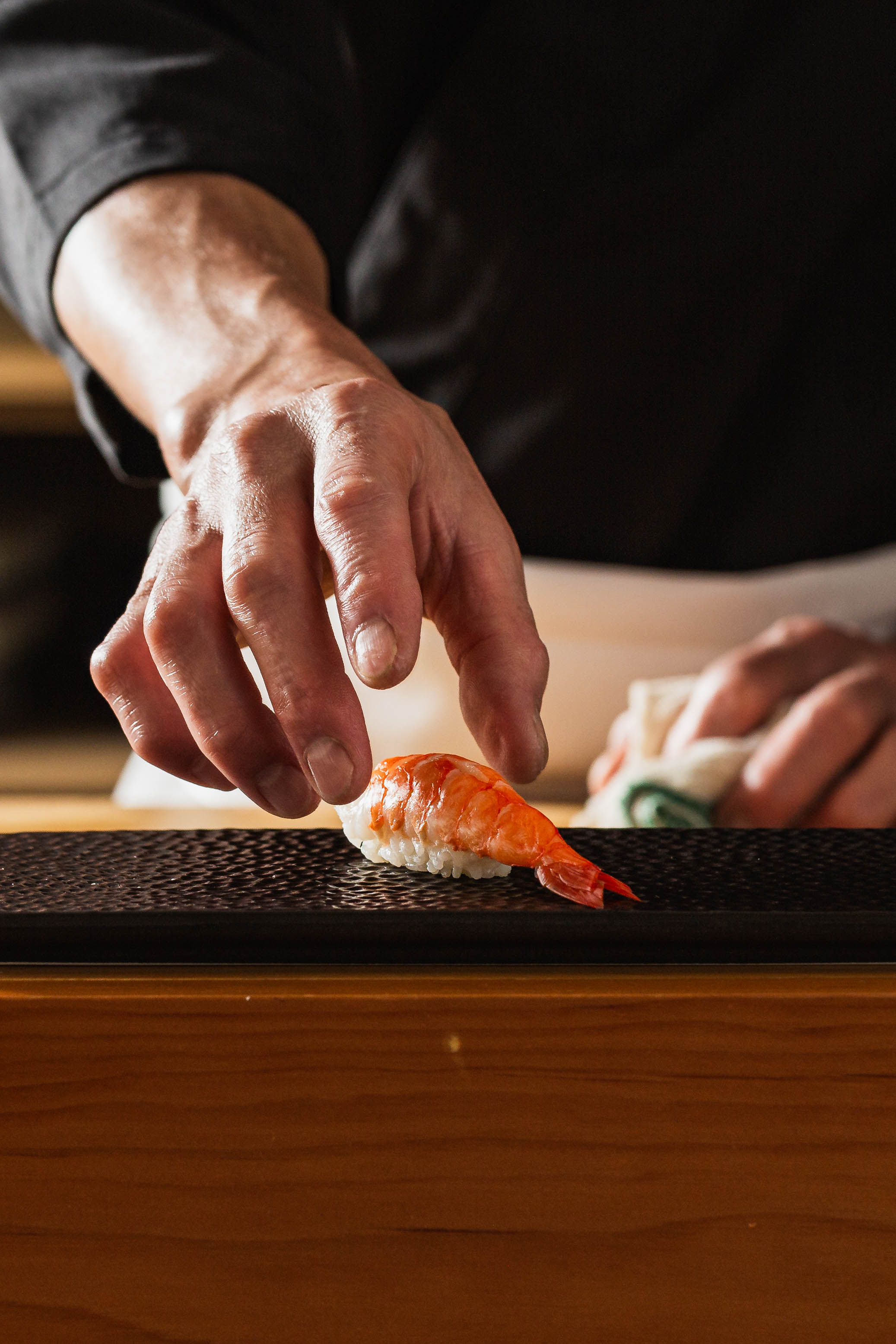 Chef placing nigiri at the counter