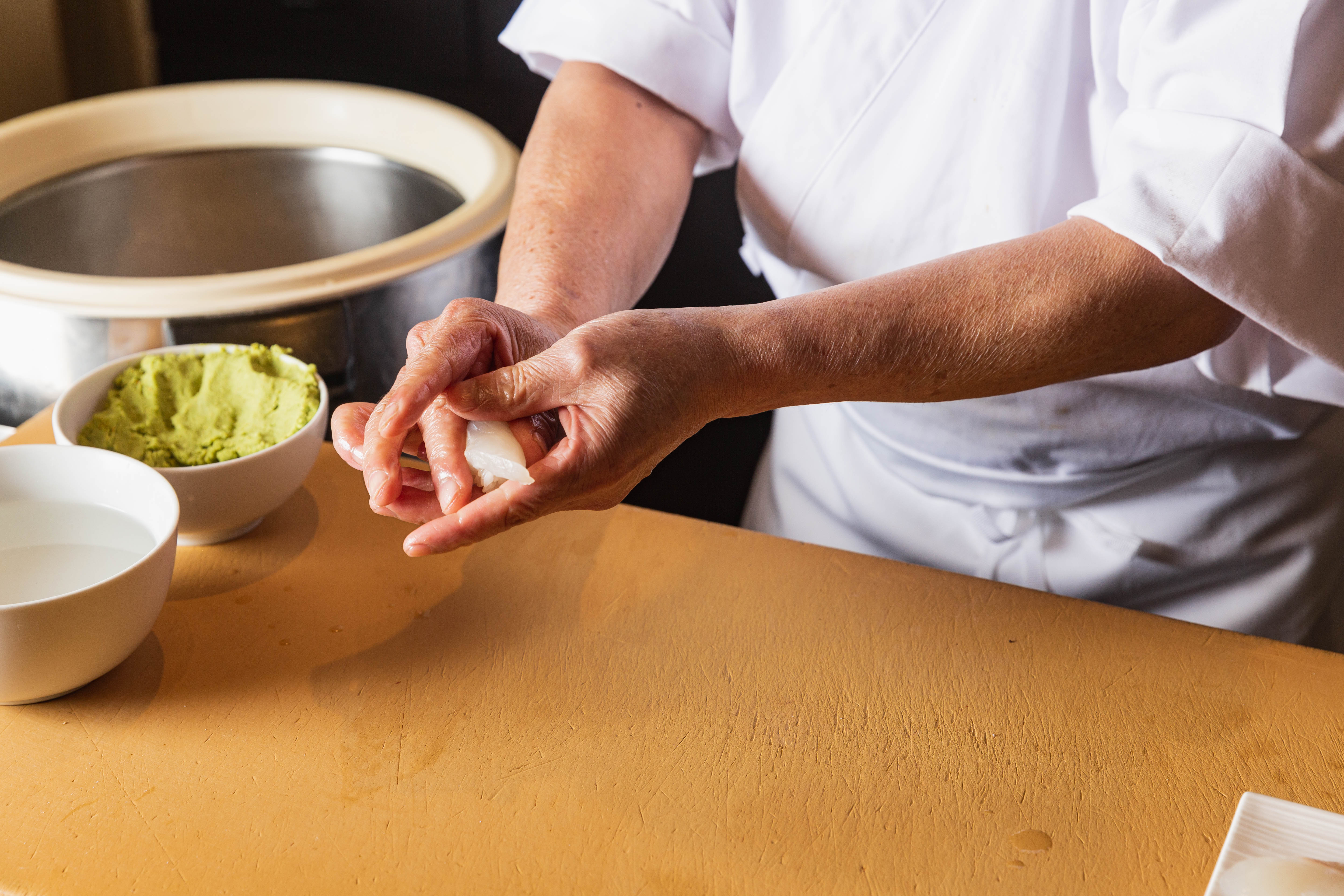 Chef placing nigiri at the counter